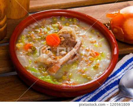 Scotch broth with barley, lamb, vegetables, peas in clay bowl 120561809