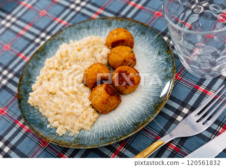Oatmeal served with meatballs on plate Oatmeal served with meatballs on plate 120561832