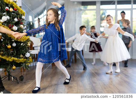 Tween girl practicing partner jive in Christmas dance studio Tween girl practicing partner jive in Christmas dance studio 120561836