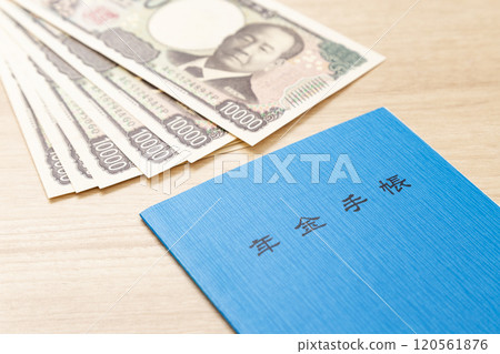 Pension book and money on a table Pension book and money on a table 120561876