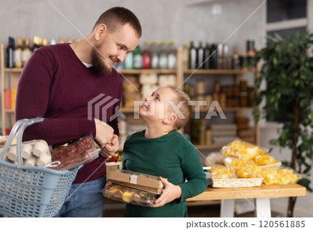 Man and his son choose groceries in a supermarket Man and his son choose groceries in a supermarket 120561885