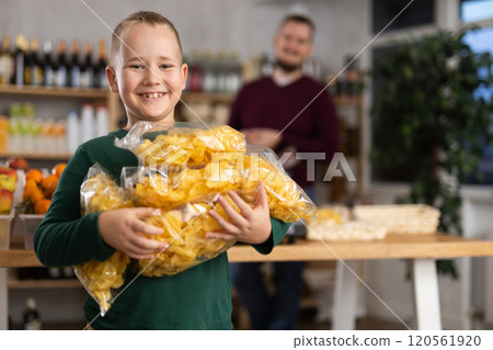 Child with packs of chips 120561920