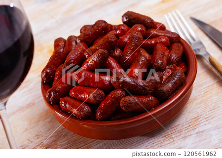 Traditional spanish hot sausage chistorritas on skewers closeup Traditional spanish hot sausage chistorritas on skewers closeup 120561962