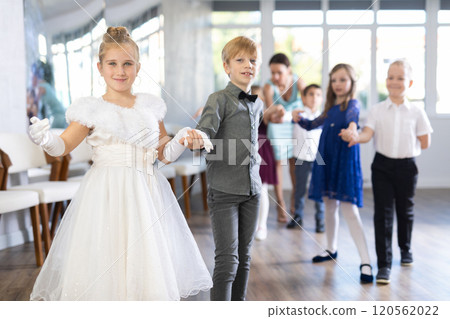 Group of preteen children movements of waltz in dance studio Group of preteen children movements of waltz in dance studio 120562022