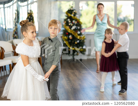Little children in festive clothes dance foxtrot dance while celebrating Christmas Little children in festive clothes dance foxtrot dance while celebrating Christmas 120562080