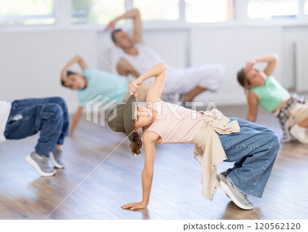 Preteen girl performing hip hop in group class for kids Preteen girl performing hip hop in group class for kids 120562120