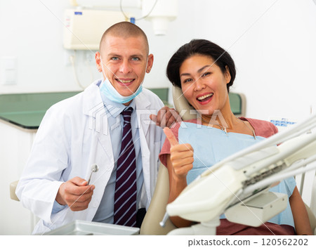 Woman is sitting satisfied in chair after treatment in dental clinic Woman is sitting satisfied in chair after treatment in dental clinic 120562202