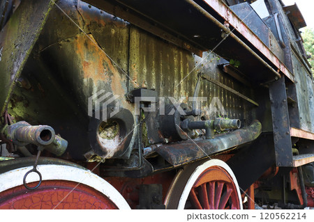 Fragment of the wheel part of an old abandoned steam locomotive. 120562214