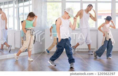 Preteen boy honing hip hop dance moves in choreographic studio 120562297