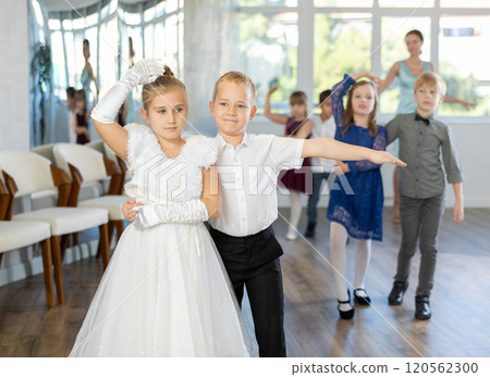 Preteen pupils rehearsing ballroom dance for festive school event Preteen pupils rehearsing ballroom dance for festive school event 120562300
