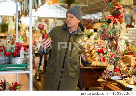 Man buying christmas decorations in shop Man buying christmas decorations in shop 120562304