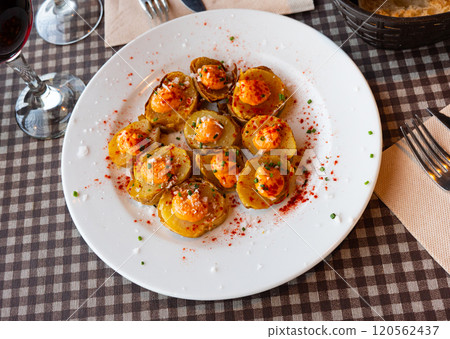 Patatas bravas with spicy sauce, paprika and greens Patatas bravas with spicy sauce, paprika and greens 120562437