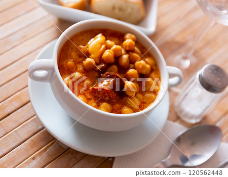 Chickpeas with chorizo served on plate in restaurant Chickpeas with chorizo served on plate in restaurant 120562448