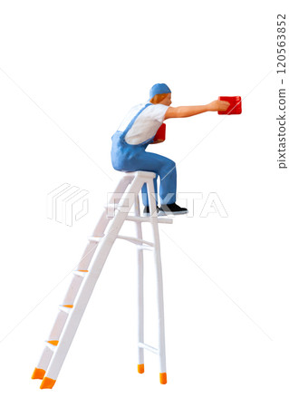 A miniature figurine of a painter seated on a ladder, holding a paint can and brush isolate on white back ground with clipping path 120563852