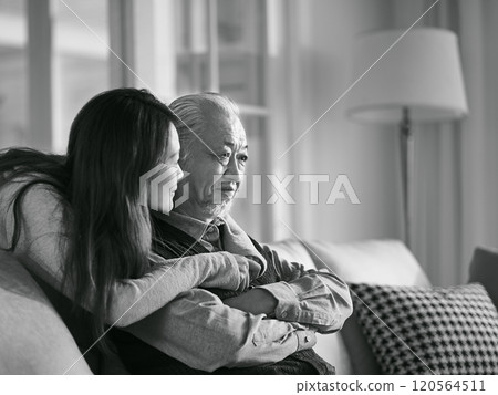 young asian daughter comforting elderly father black and white young asian daughter comforting elderly father black and white 120564511
