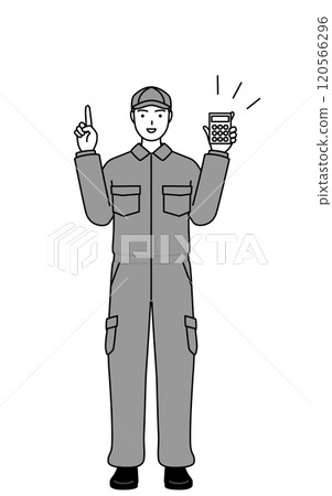 A mechanic in overalls holding a calculator and pointing 120566296