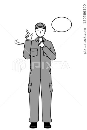 A mechanic in overalls operating a smartphone A mechanic in overalls operating a smartphone 120566300
