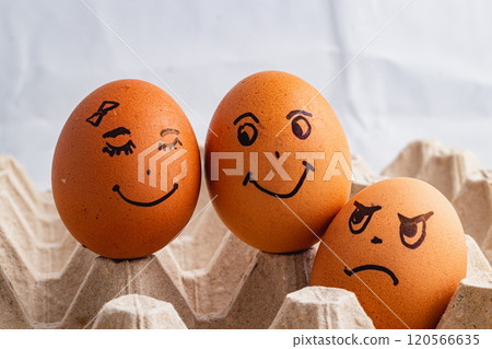 Happy couple of eggs smiling, envious angry and jealous stranger on the side 120566635