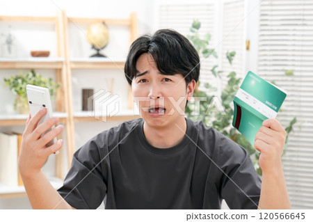 A worried man holding a bankbook A worried man holding a bankbook 120566645
