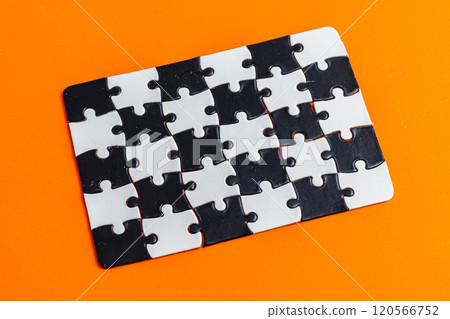 Black and white puzzle, teamwork challenge concept on orange background. 120566752