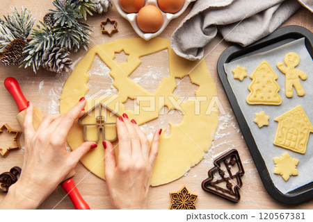 Pastry chef making christmas cookies using dough cutters 120567381