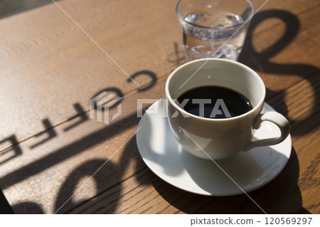 Coffee and water on a table in a coffee shop Coffee and water on a table in a coffee shop 120569297