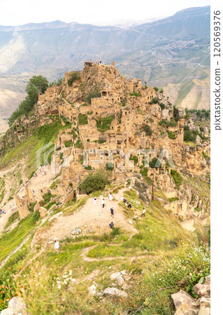 Dagestan Gamsutl. Ancient ghost town of Gamsutl old stone houses in abandoned Gamsutl mountain village in Dagestan, Abandoned etnic aul, summer landscape. 120569376