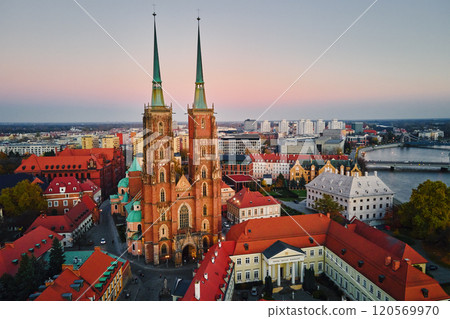 Aerial view of European city with Gothic churches and historic architecture in autumn season. St. John Cathedral on Ostrow Tumski at sunset. Cityscape panorama of Wroclaw, Poland Aerial view of European city with Gothic churches and historic architecture in autumn season. St. John Cathedral on Ostrow Tumski at sunset. Cityscape panorama of Wroclaw, Poland 120569970