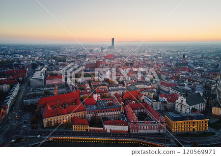 Aerial view of Wroclaw old town with red roofs, churches and the Sky Tower building in background at sunset. Panorama of Wroclaw, Poland Aerial view of Wroclaw old town with red roofs, churches and the Sky Tower building in background at sunset. Panorama of Wroclaw, Poland 120569971