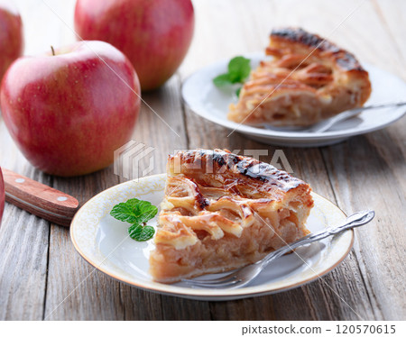 Apple pie (cut image) on old wooden background 120570615