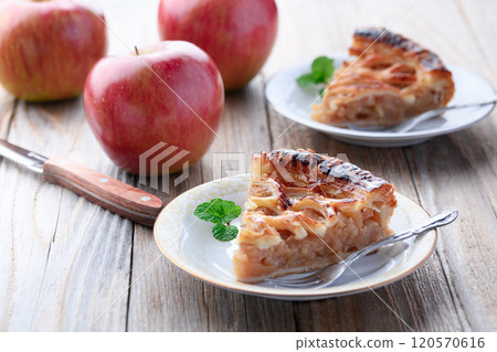 Apple pie (cut image) on old wooden background 120570616