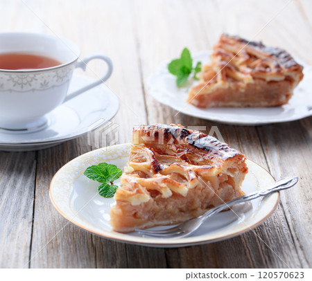 Apple pie (cut image) on old wooden background 120570623
