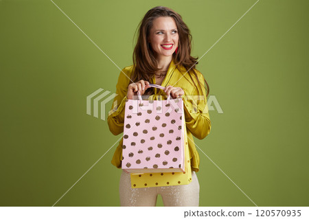 smiling fit 40 years old woman against green background smiling fit 40 years old woman against green background 120570935