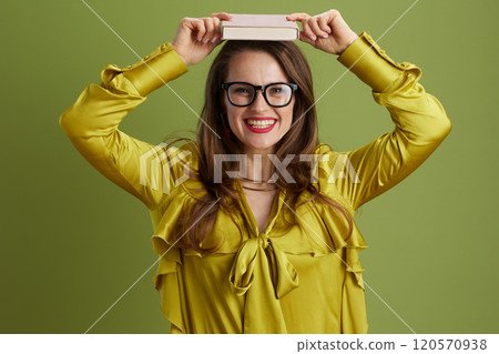 smiling healthy woman in green blouse and glasses on green smiling healthy woman in green blouse and glasses on green 120570938