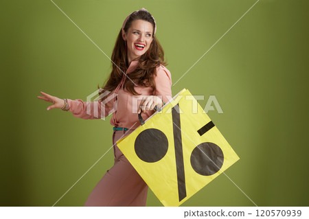 happy modern woman in pink blouse isolated on green background happy modern woman in pink blouse isolated on green background 120570939
