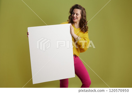 happy healthy female showing blank board isolated on green happy healthy female showing blank board isolated on green 120570950