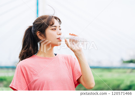 A woman drinking water A woman drinking water 120571466