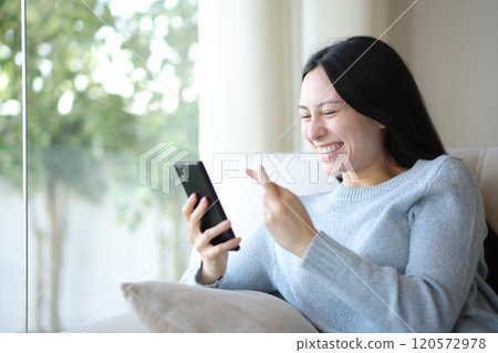 Happy asian woman crossing fingers checking cell phone 120572978