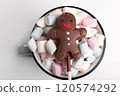 Chocolate man on marshmallow cup, sweet Christmas cookies, close-up, top view 120574292