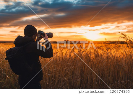 Photographer Capturing Golden Hour in a Field of Wheat 120574595