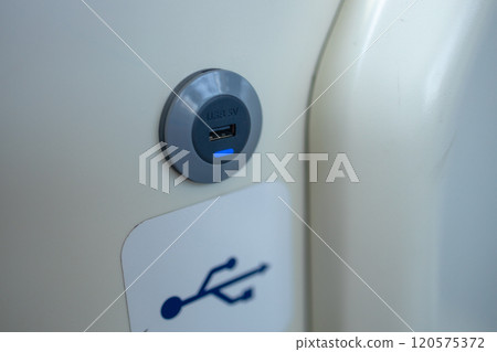 USB sockets in a tram car. USB port in a passenger carriage in Europe for charging gadgets and electronics 120575372