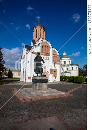 A scenic view of historic churches surrounded by greenery under a vibrant blue sky with scattered clouds. The architecture highlights cultural heritage and peaceful natural surroundings. 120575463