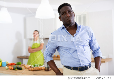 Portrait of man having quarrel with his wife in kitchen Portrait of man having quarrel with his wife in kitchen 120575937