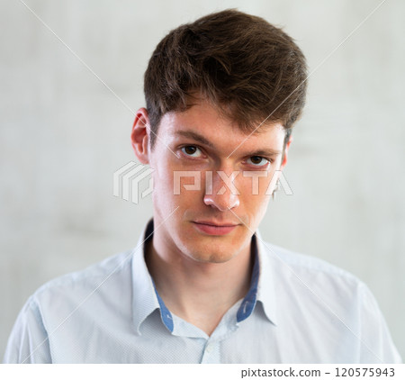 Portrait of young serious guy in studio 120575943