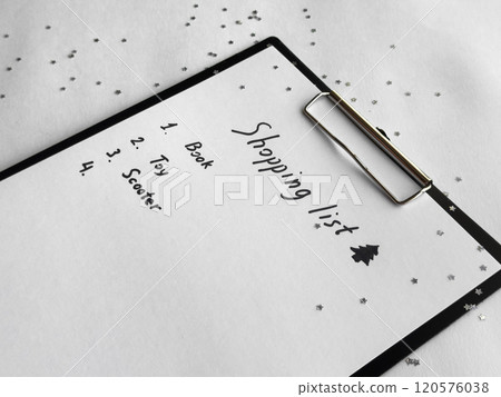Holiday shopping list on festive clipboard with star confetti and seasonal decorations Holiday shopping list on festive clipboard with star confetti and seasonal decorations 120576038