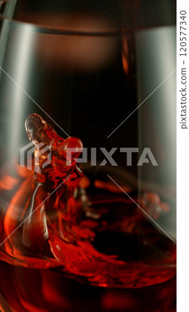Close-up of red wine pouring into glass , freeze motion. Close-up of red wine pouring into glass , freeze motion. 120577340