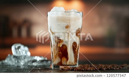 Freeze Motion Shot of Pouring Milk into Coffee in a Cafe Freeze Motion Shot of Pouring Milk into Coffee in a Cafe 120577347