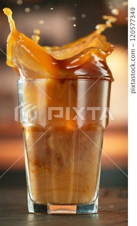 Macro Shot of Splashing Ice Cube into Coffee, Close-up Macro Shot of Splashing Ice Cube into Coffee, Close-up 120577349