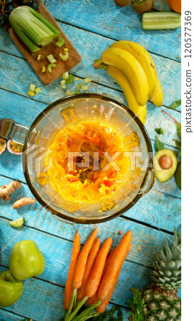 Fresh fruit and vegetables smoothie blended in blender, top view. Healthy eating concept. Freeze motion. 120577369