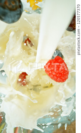 Fresh fruit and vegetables smoothie blended in blender, top view. Healthy eating concept. Freeze motion. 120577370